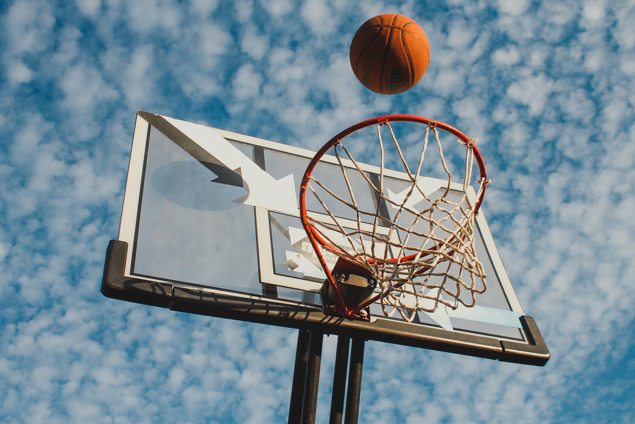 Low-Angle Shot of Basketball Hoop under the Cloudy Sky